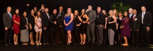 The 24 associates who received awards stand on stage at the Best of the Best