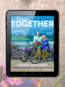 An image showing the Time Together digital magazine on a tablet. There are two timeshare owners on bikes standing in front of the ocean near Carlsbad.