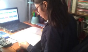 Girl at Christel House Mexico City using donated laptop