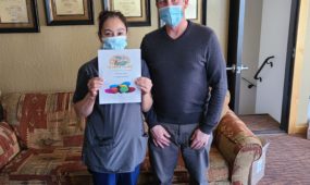 Rosario Rojas holding 2020 BE EPIC Champion Award