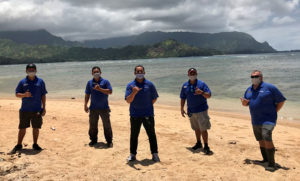 Maintenance Team standing on beach at Hanalei Bay Resort