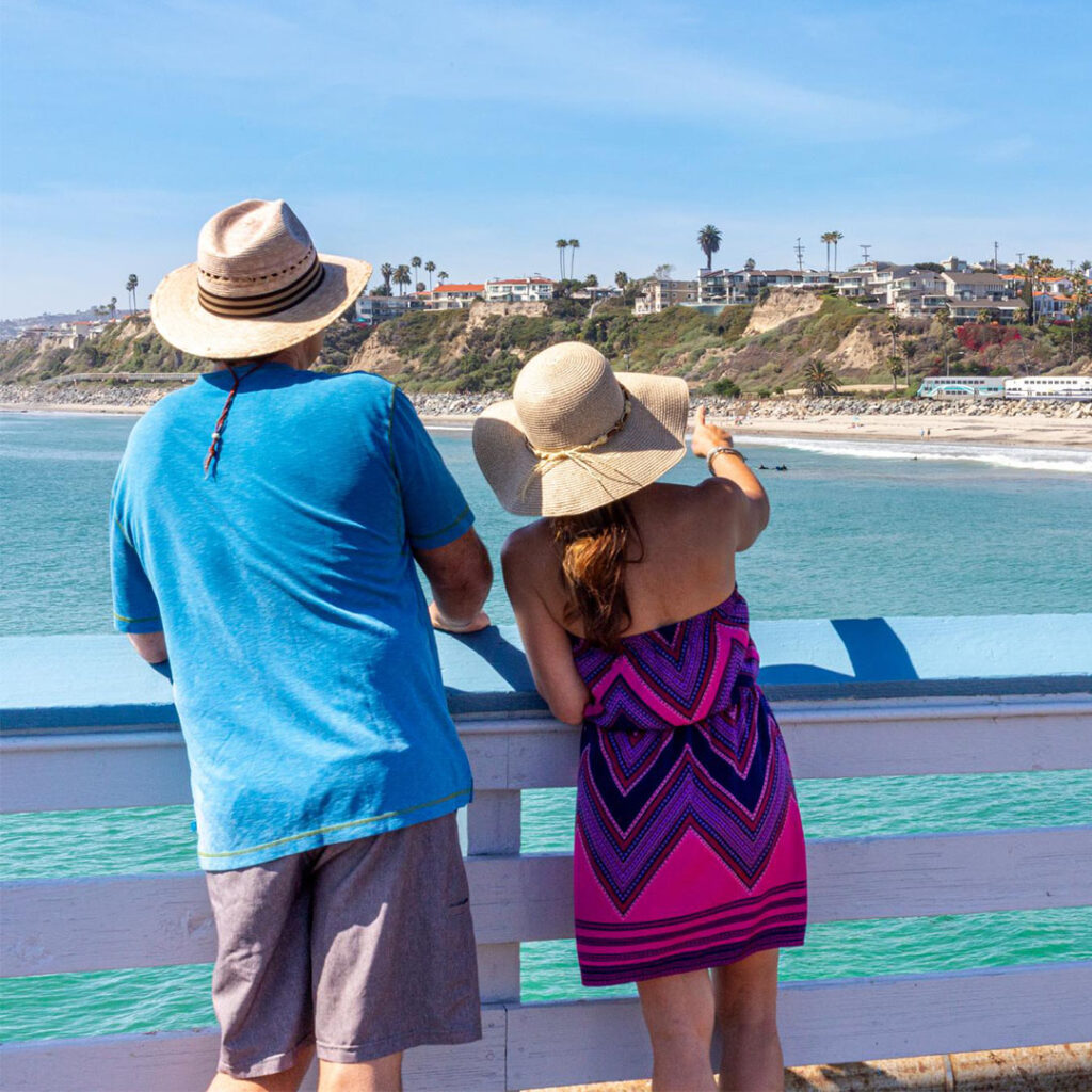 couple standing on san clemente pier