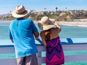 couple standing on san clemente pier